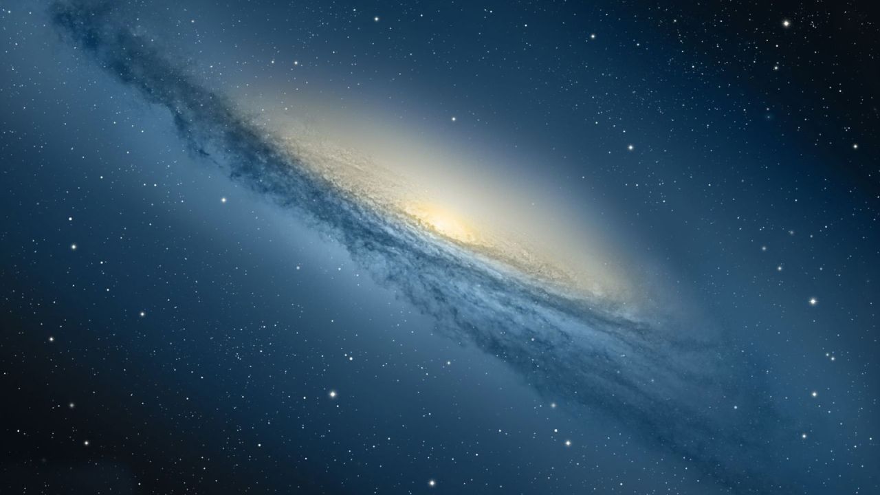 Galaxy in deep space with bright core and stars