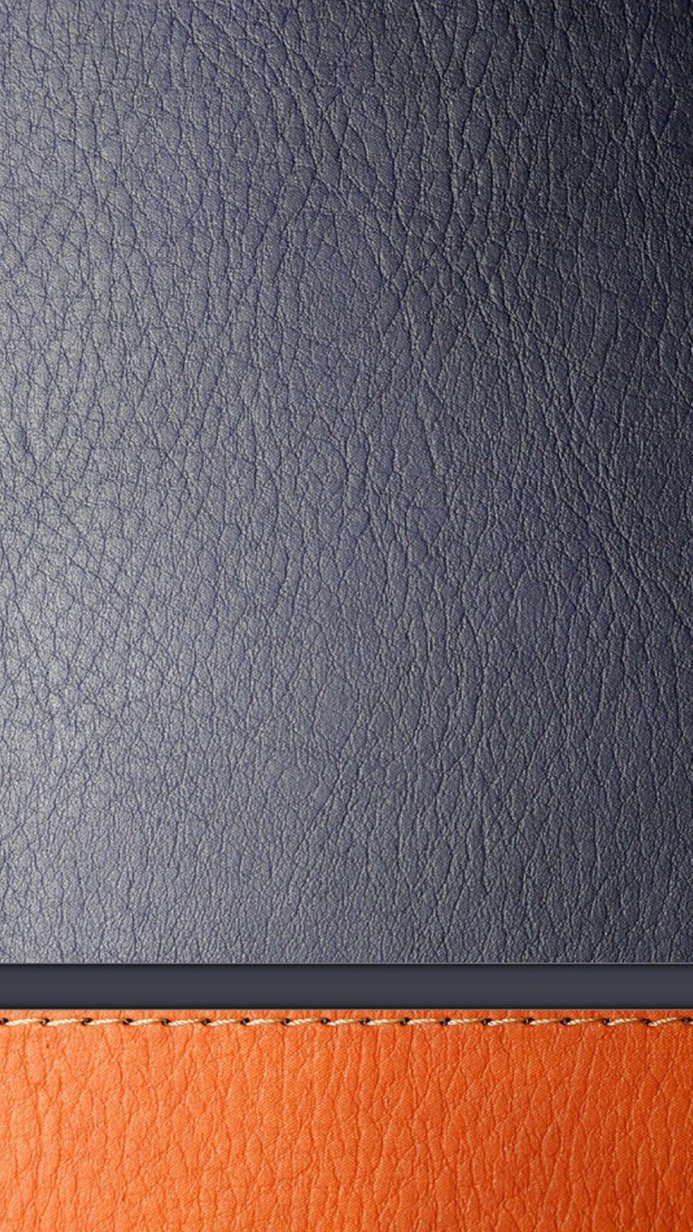 Close-up of blue and orange leather texture, with stitching detail