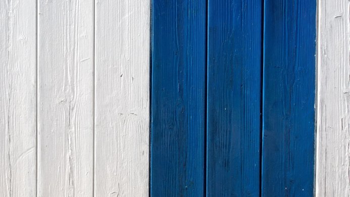 Blue and white painted wooden planks forming an abstract pattern