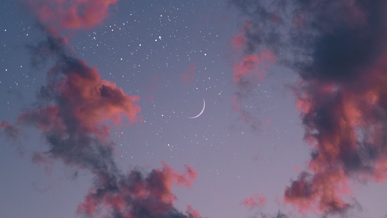 Night sky with crescent moon stars and clouds