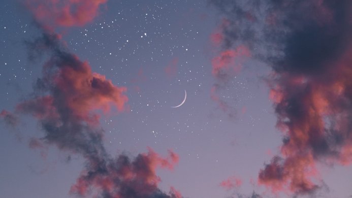 Crescent moon with stars and pink clouds in a blue and purple sky