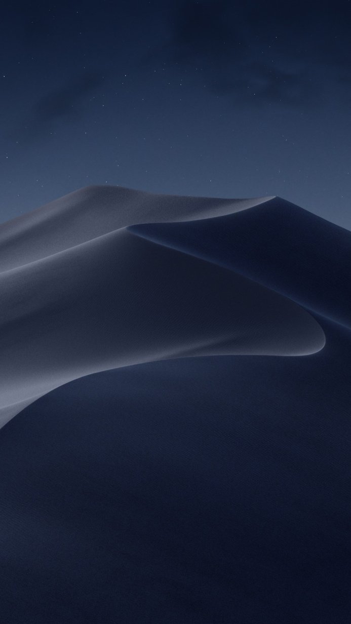 Dark blue sand dunes under a night sky with stars