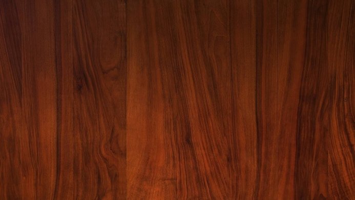 Close-up of a dark brown wood surface showing the grain pattern