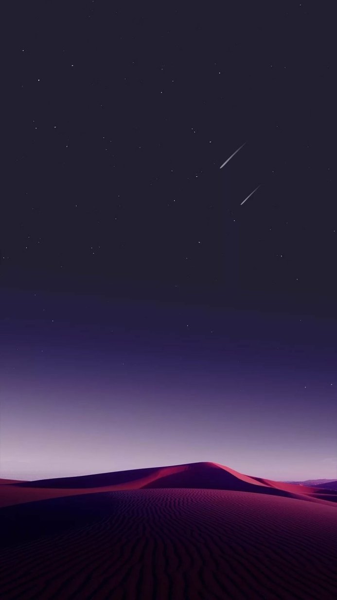 Desert landscape at night with falling stars in a purple color palette