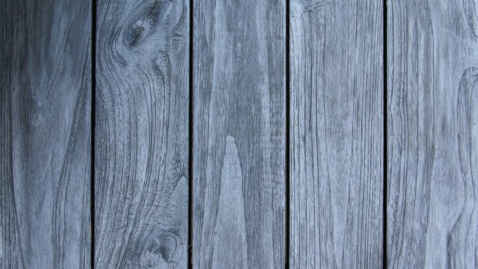 Close-up of gray-blue wooden planks with visible wood grain pattern