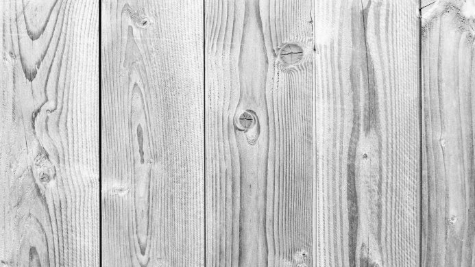 Close-up of grey and white wooden planks with visible wood grain patterns
