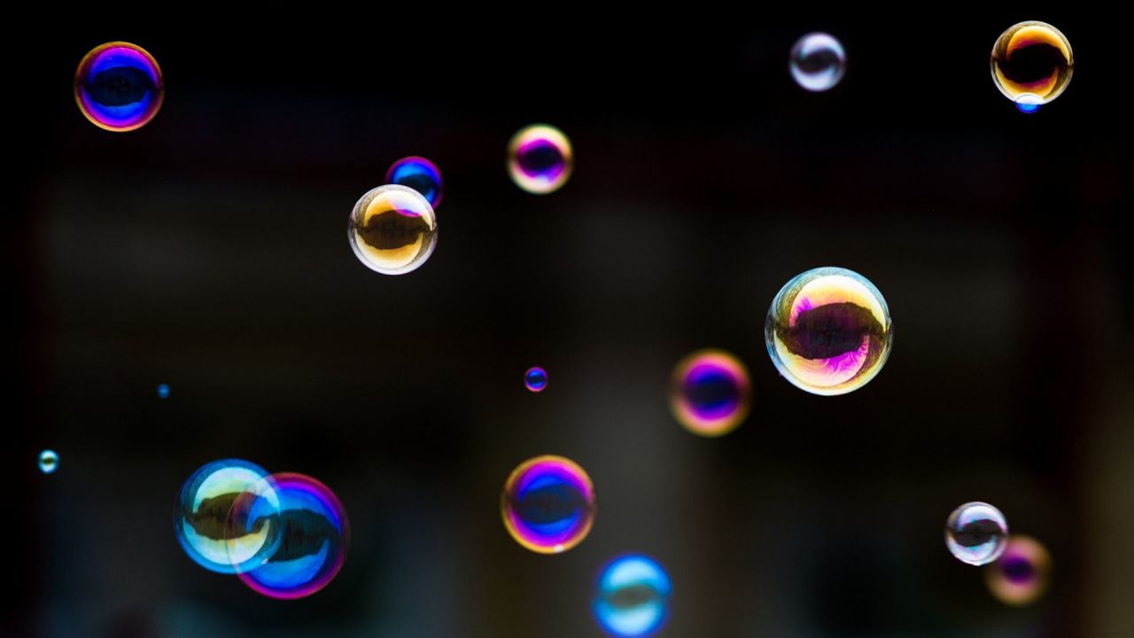 Colorful soap bubbles against a dark background