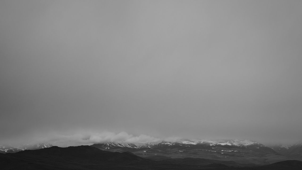 Black and white landscape mountains snow clouds