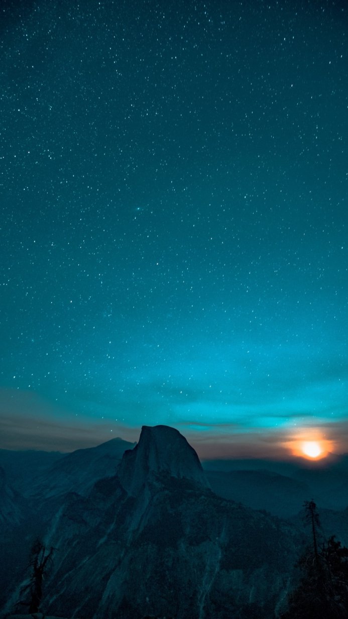 Night landscape with mountains and a sky full of stars