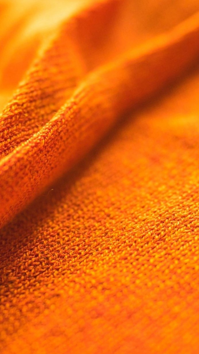 Close-up of orange fabric showing detailed texture and folds