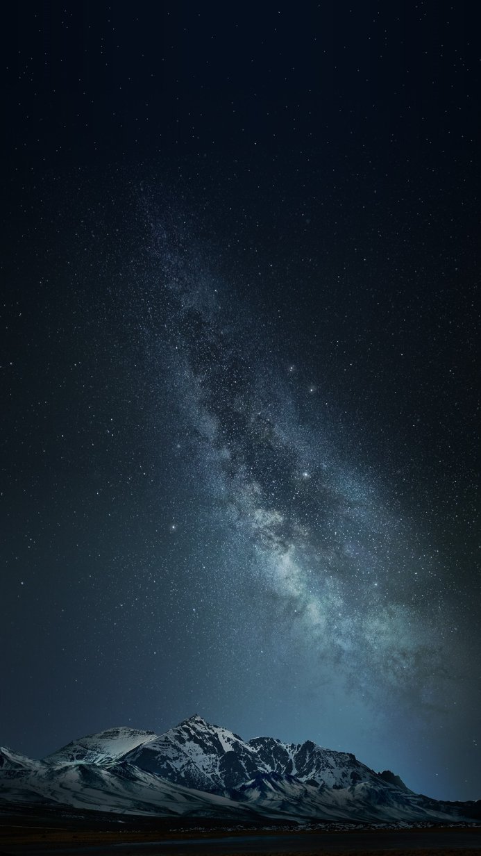 Snowy mountains under the Milky Way at night