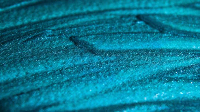 A sparkling teal texture with horizontal lines