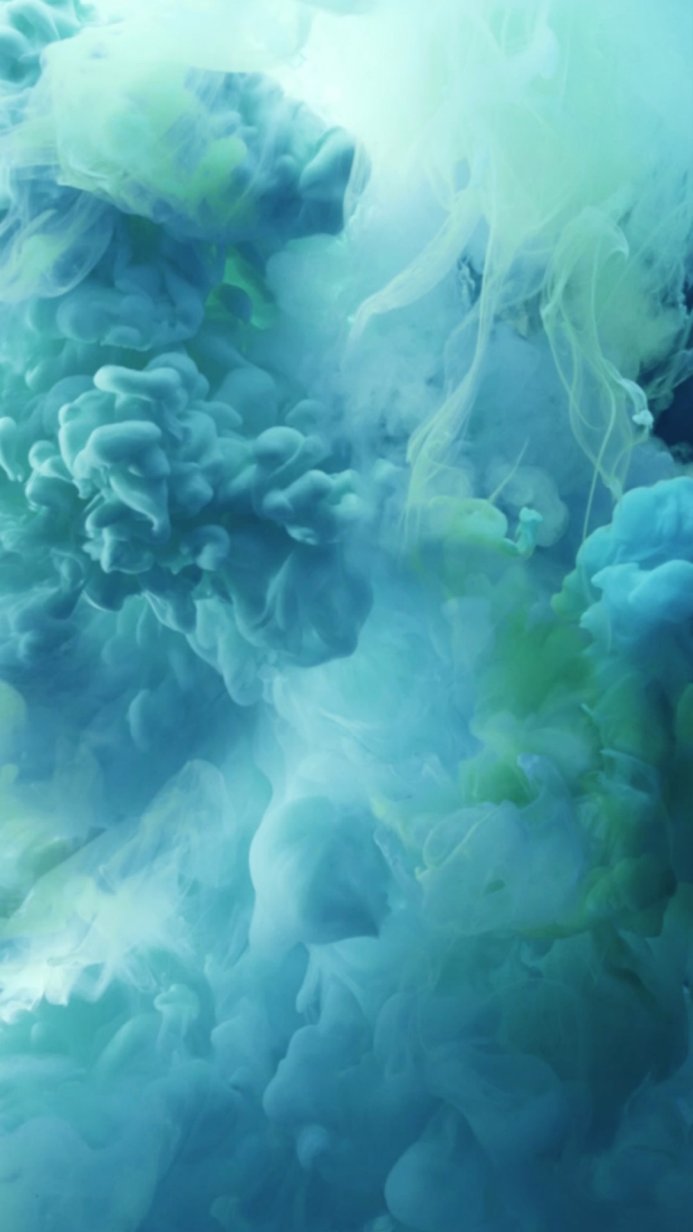 Swirling turquoise and green smoke underwater abstract design