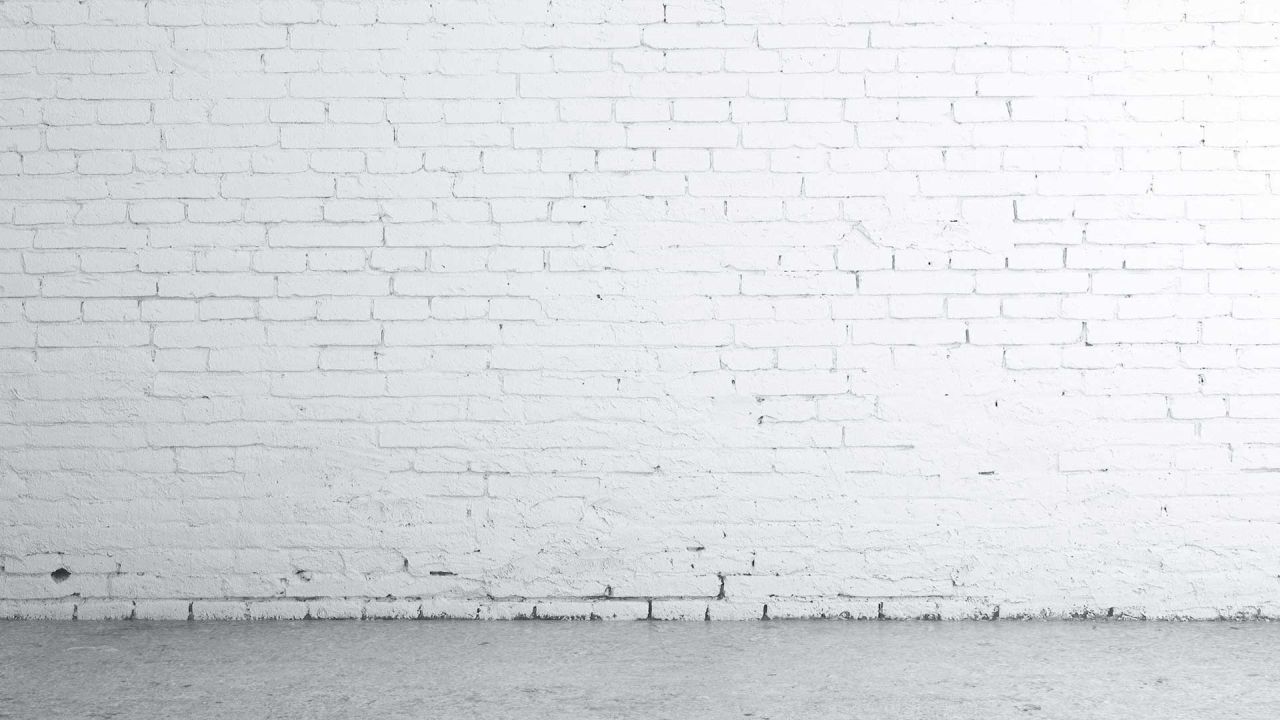 White painted brick wall and concrete floor background