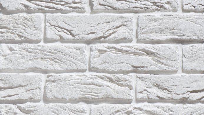 Close-up of a white brick wall with a textured surface