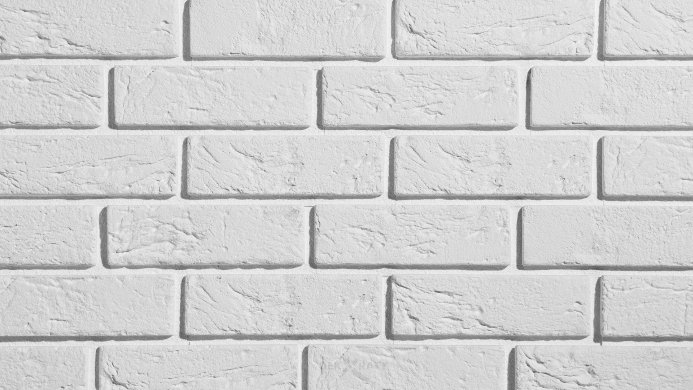 A close-up of a white painted brick wall texture