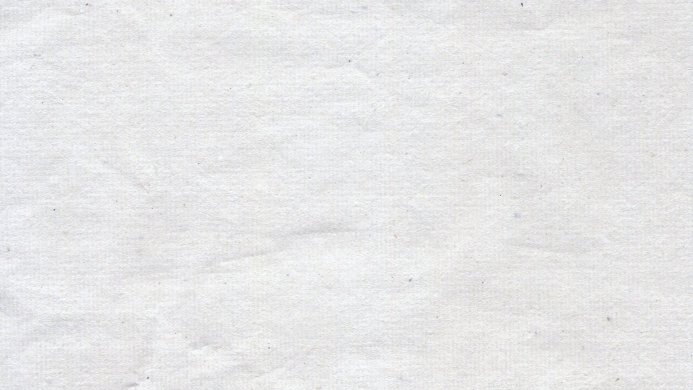 Close-up of white paper texture with subtle variations in tone and surface detail