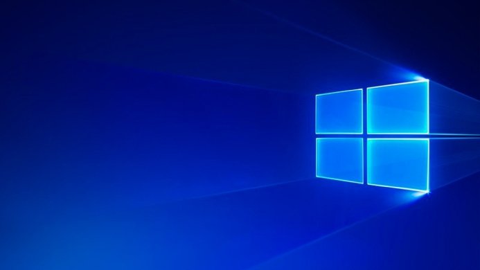 The Windows logo in vibrant blue hues, floating on a dark blue background