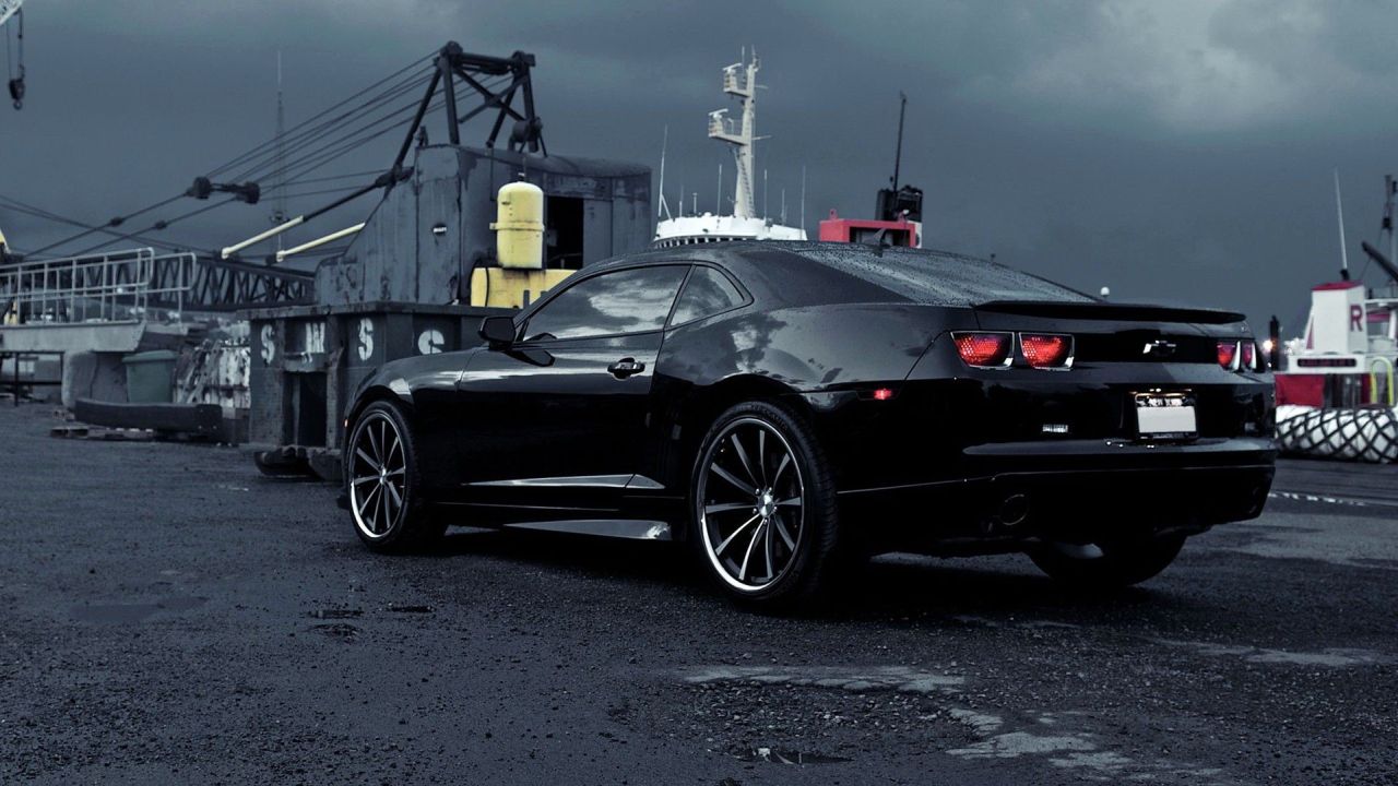 Black Chevrolet Camaro on a dock