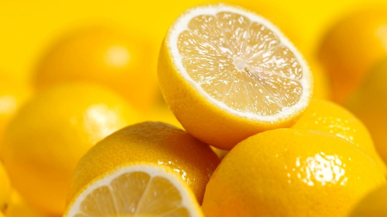 Pile of lemons on a yellow background