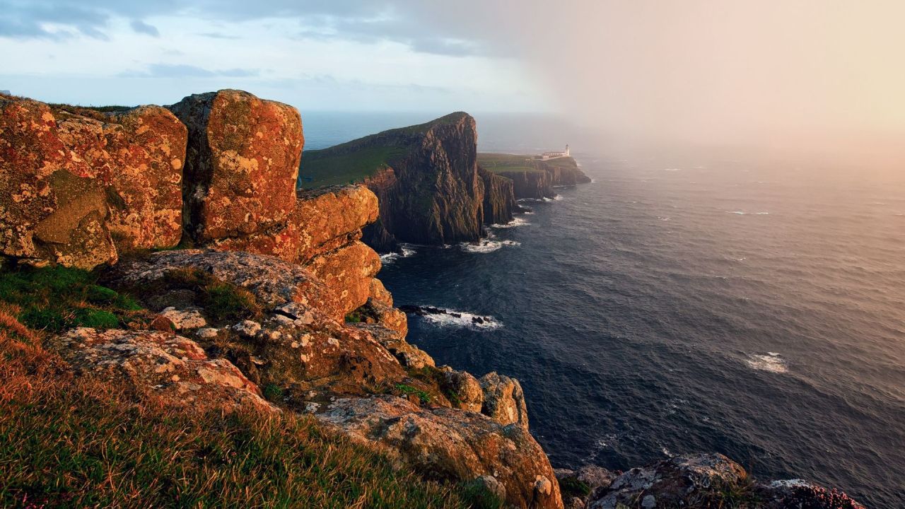 Lighthouse on rocky cliffs by the sea