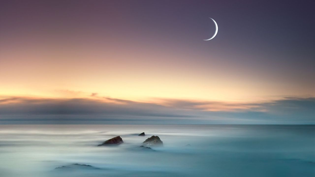 Crescent Moon at sunset over the sea