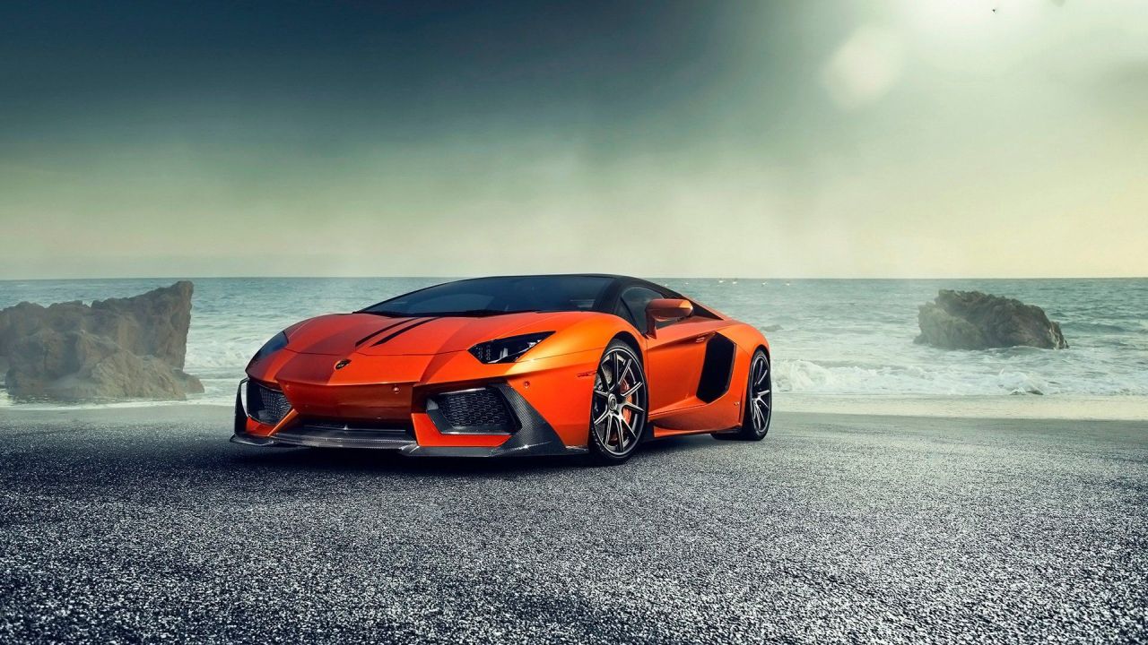 Orange Lamborghini Aventador on a beach