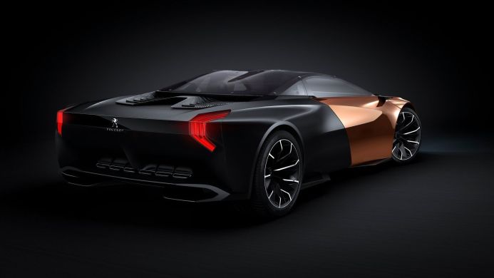 Peugeot concept car in black and copper with red taillights, rear view