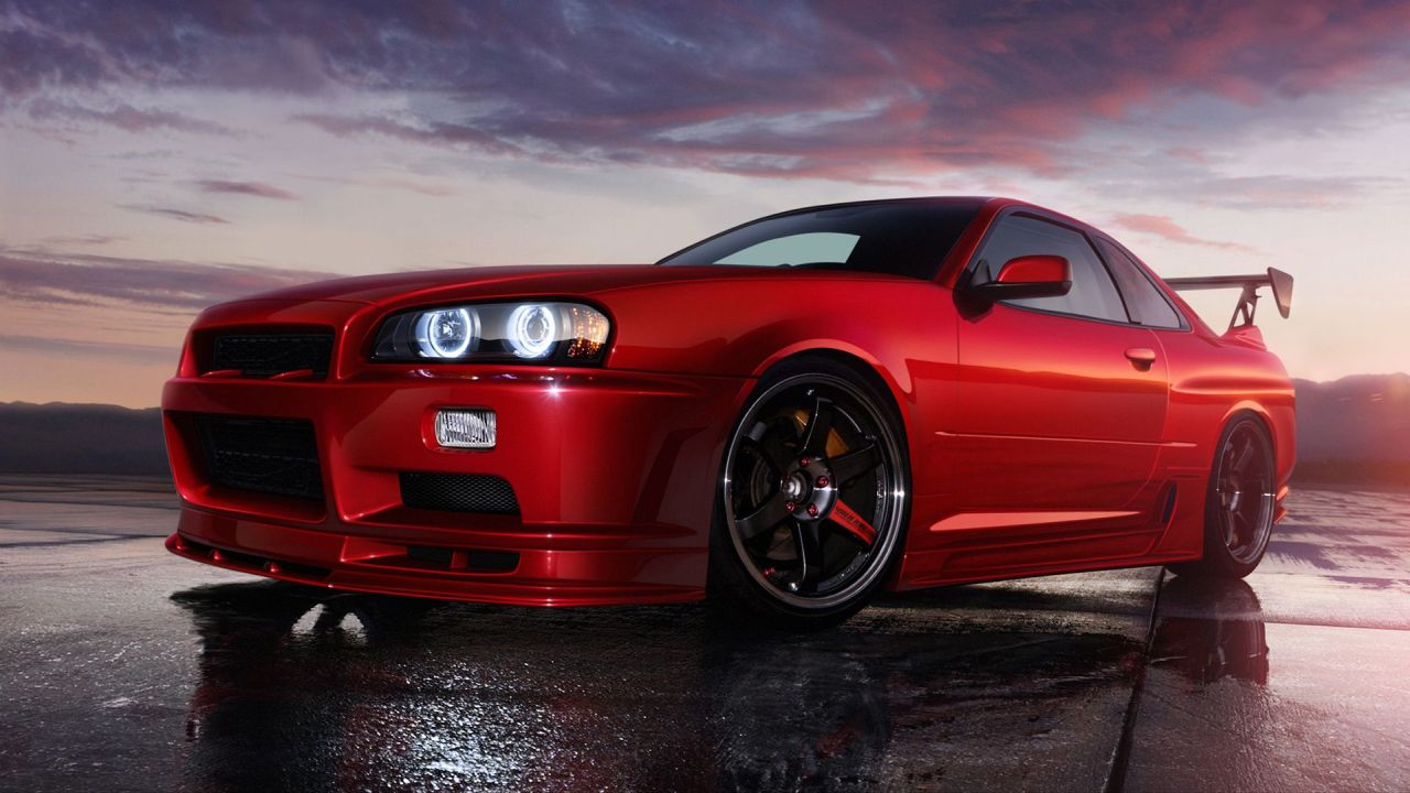 Red sports car on wet ground