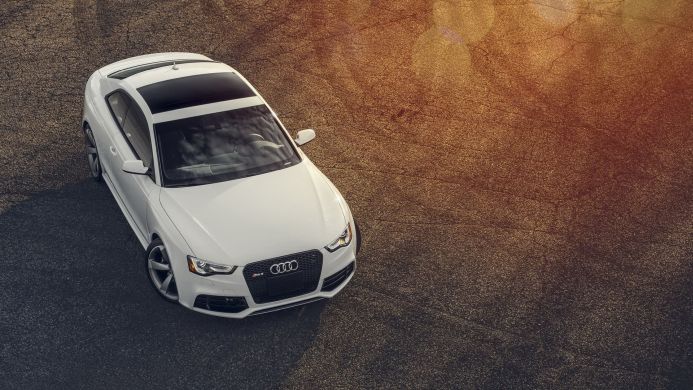 White Audi RS5 sports car parked on asphalt, overhead shot
