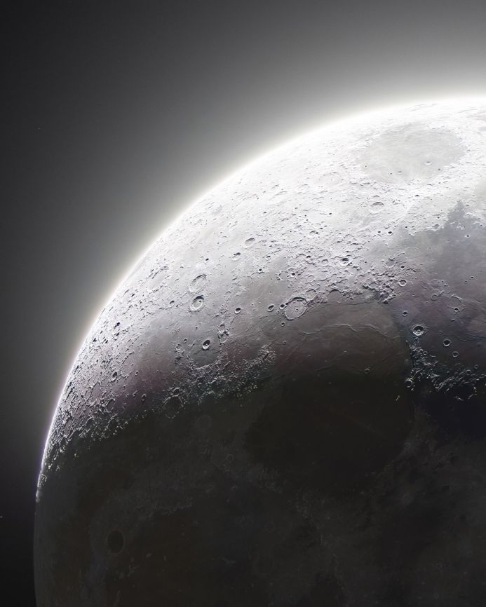 Detailed view of the moon's surface with craters and a bright halo