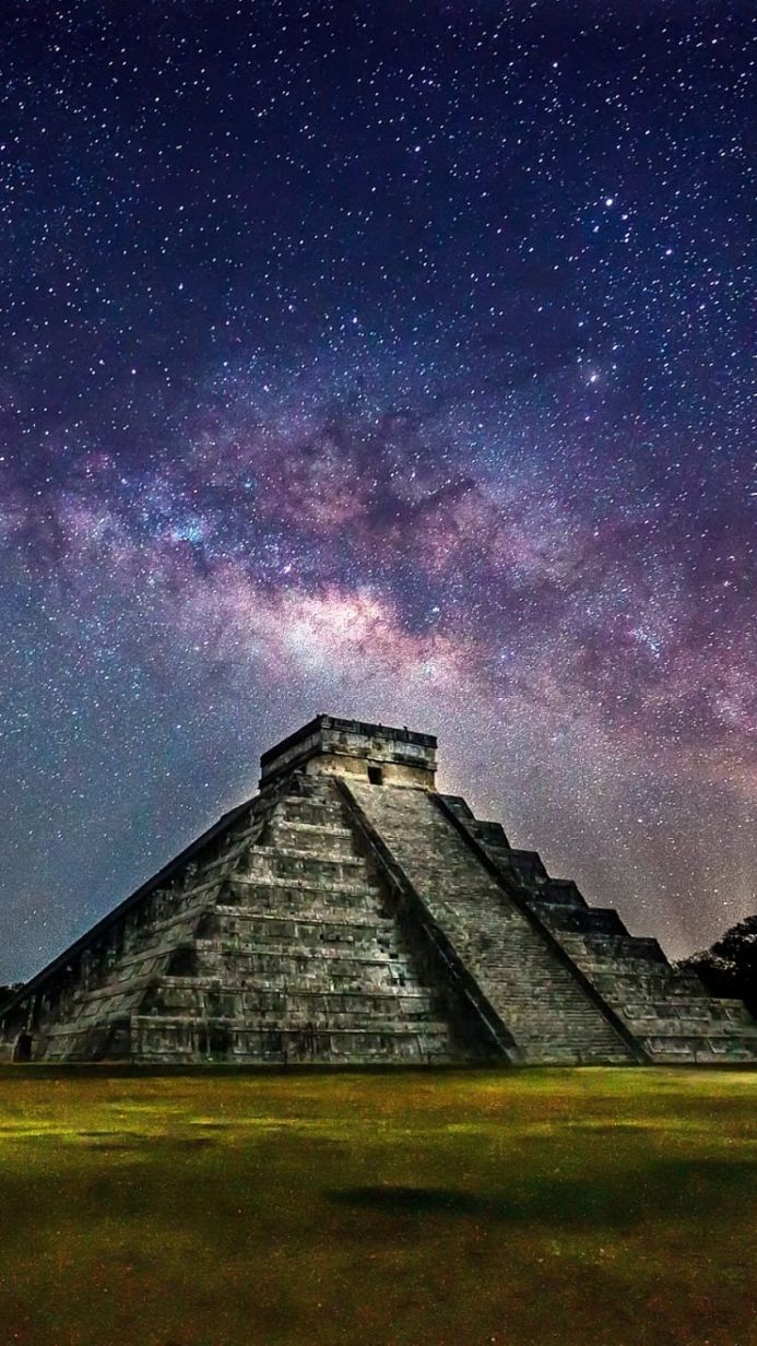 The Pyramid of Kukulkan at Chichen Itza under a starry night sky