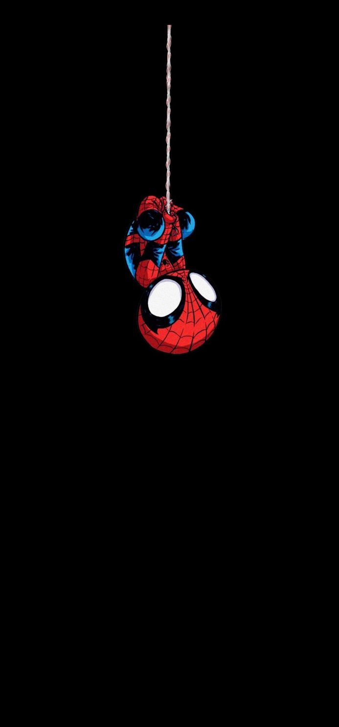 Spider-Man hanging upside down on a string against a black background