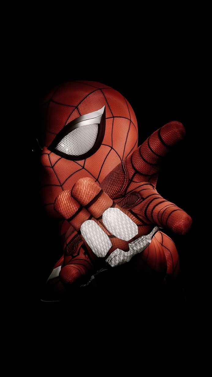 Close-up of Spider-Man's mask and hand against a black background