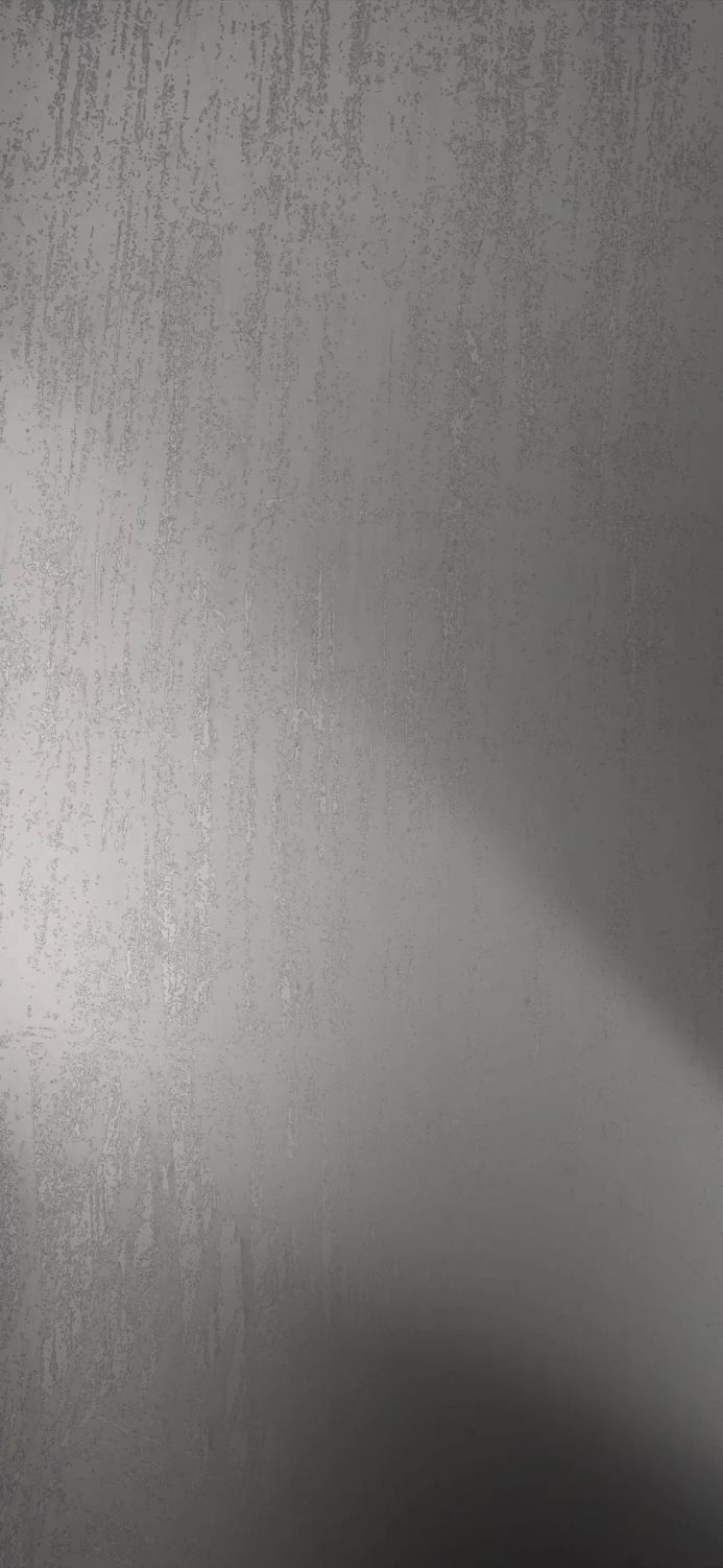 Close-up of textured gray wall with subtle patterns and shading