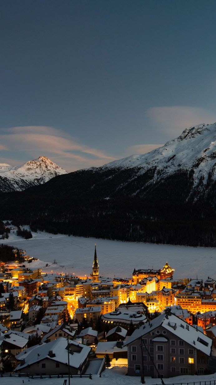 Aerial view of a town nestled in the mountains at twilight