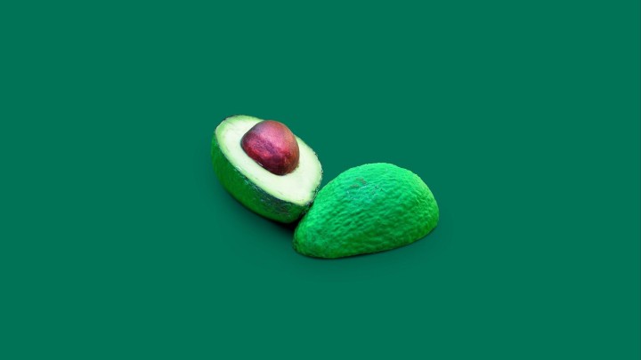Avocados and avocado oil on wooden board