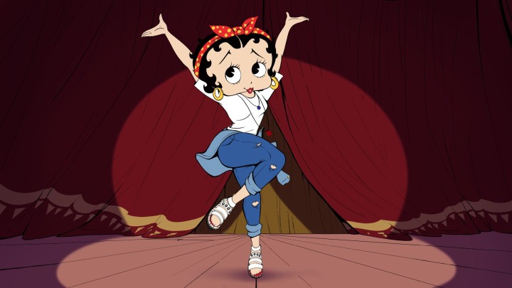 Betty Boop dancing on a stage in jeans