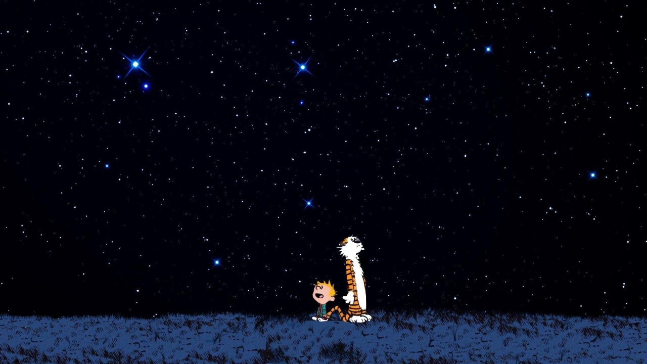 Calvin and Hobbes sitting on a bench viewed from back