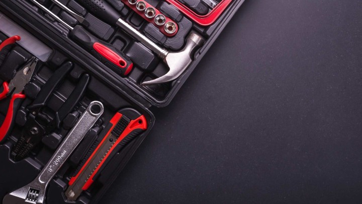 Collection of hand tools on a dark background
