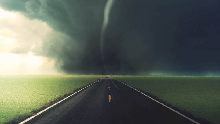 Dramatic tornado lightning and windmill on a road