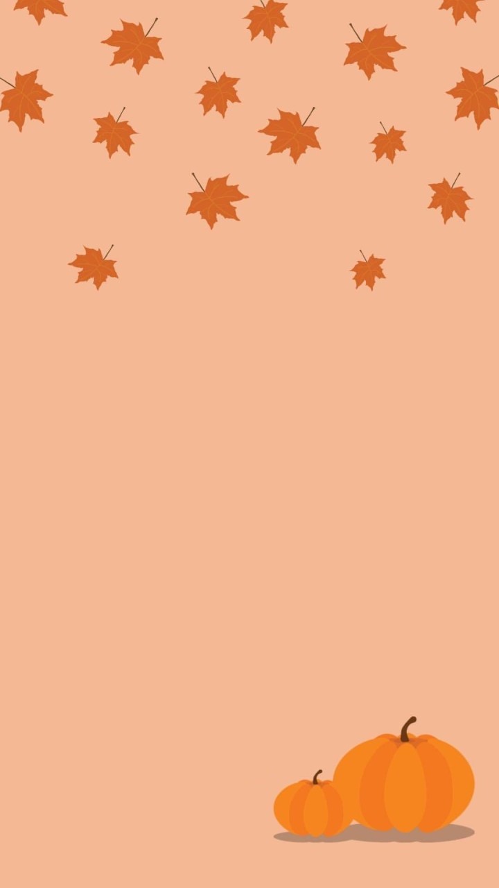 Falling autumn leaves and two orange pumpkins