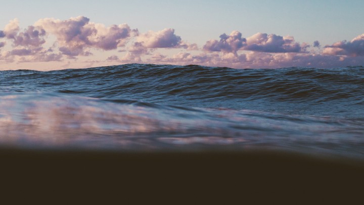 Ocean waves sunset sky split view