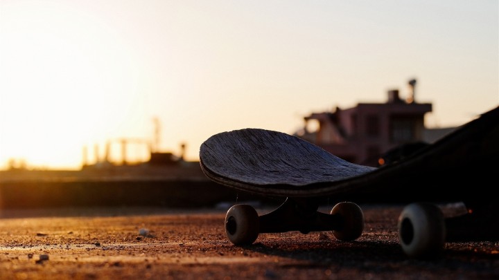 Old skateboard close up on textured surface