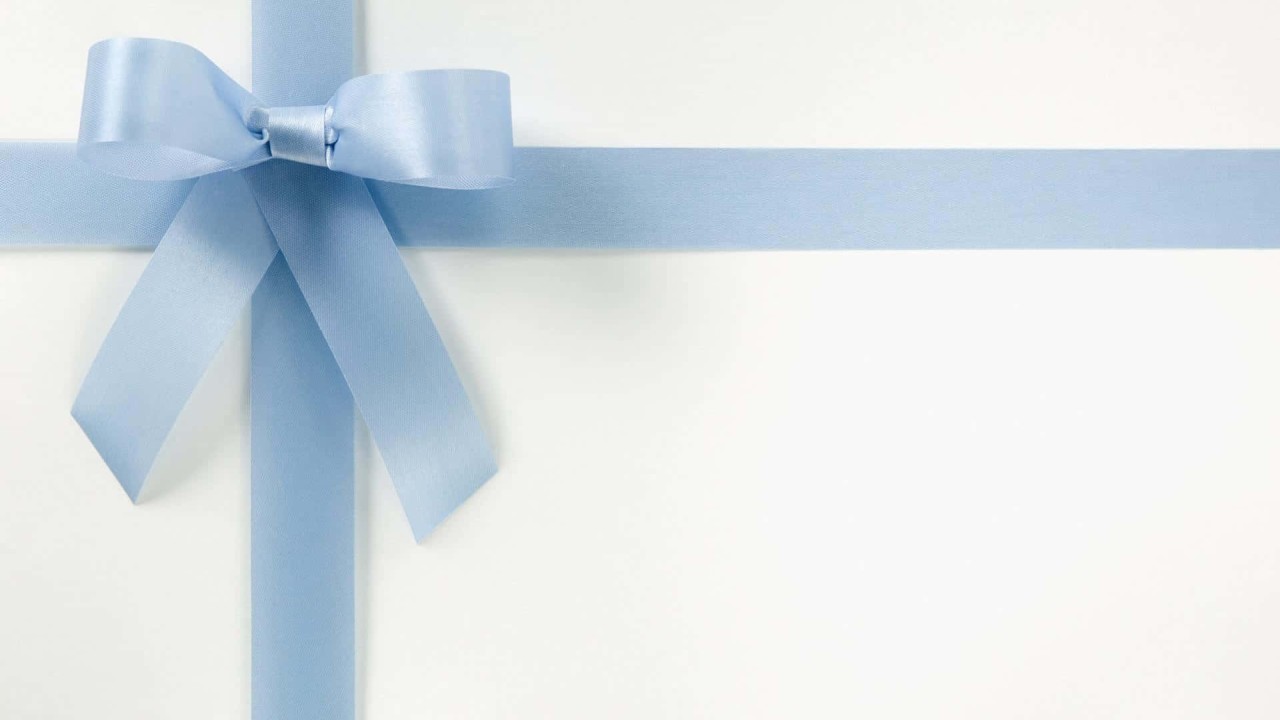 Pale blue ribbon bow on a white background