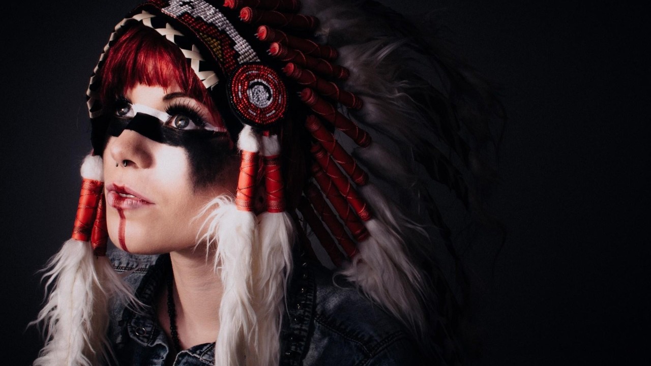 Person in feathered headdress with face paint