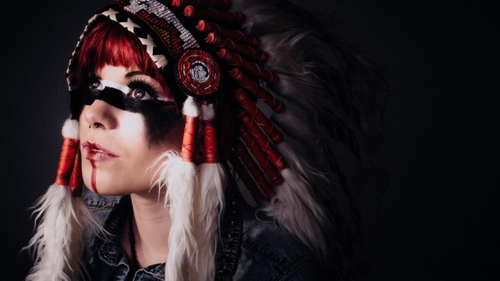 Person in feathered headdress with face paint