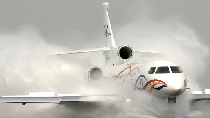 Private jet in water salute ceremony at airport