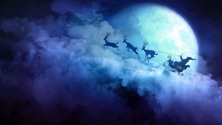Santa Claus on a snowy roof delivering a large gift