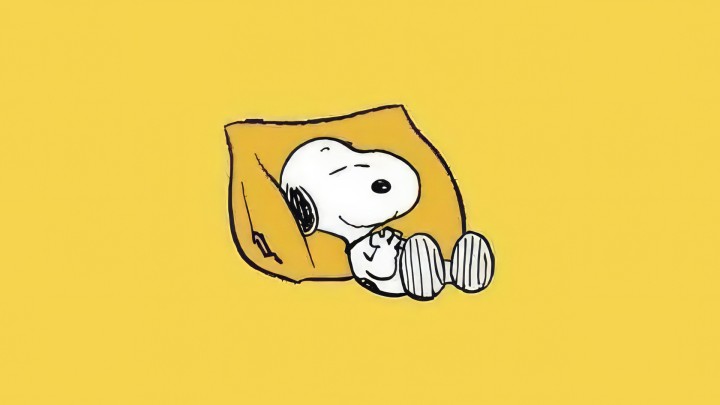 Snoopy sleeping on a yellow pillow simple background